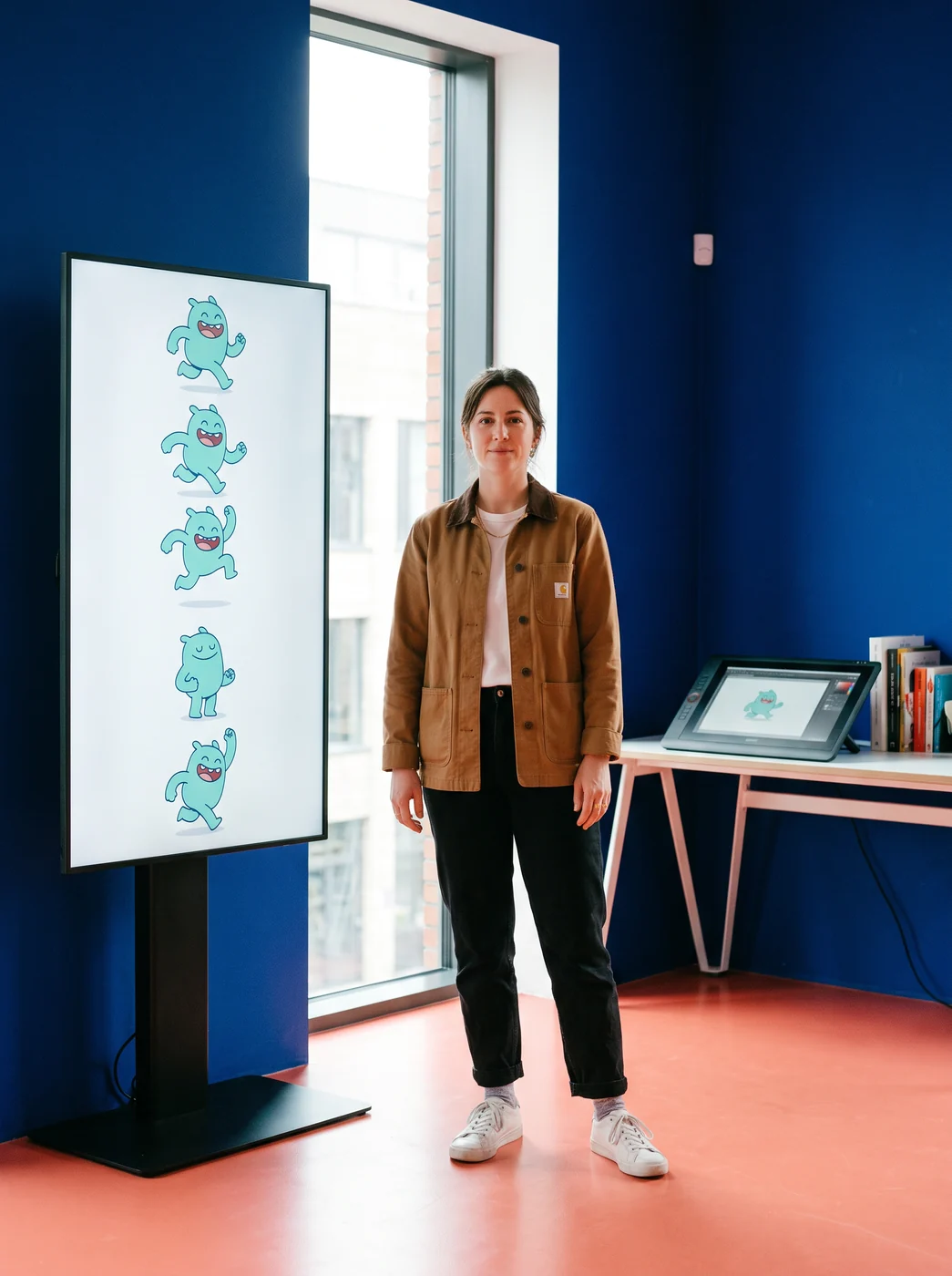 Artist standing beside a vertical character display