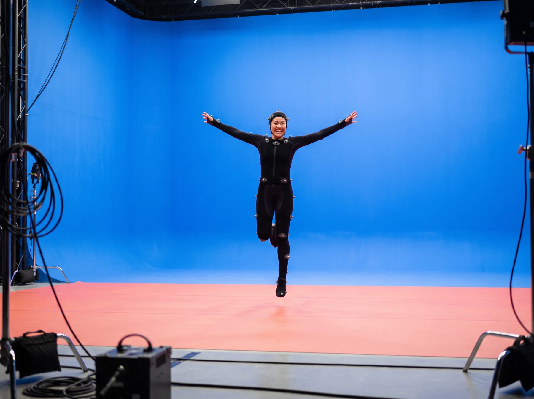 Performer posing in front of a blue studio screen